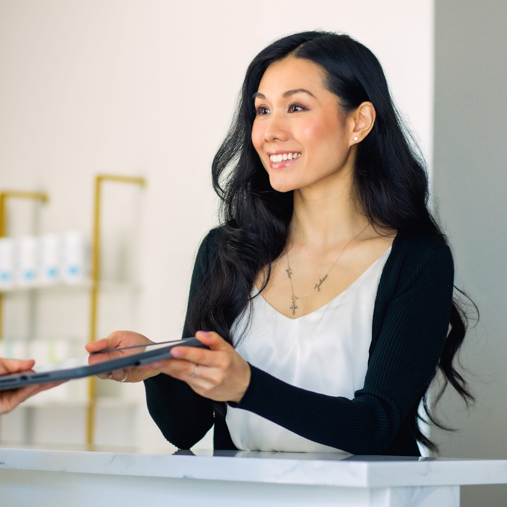 woman handing over an ipad