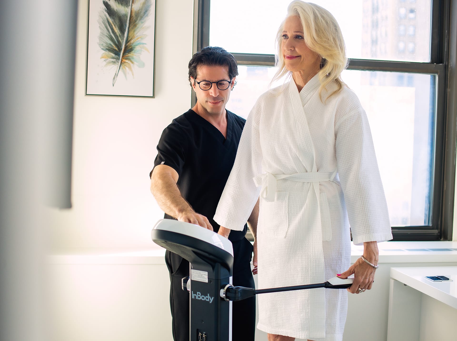 patient wearing a robe standing on a scale