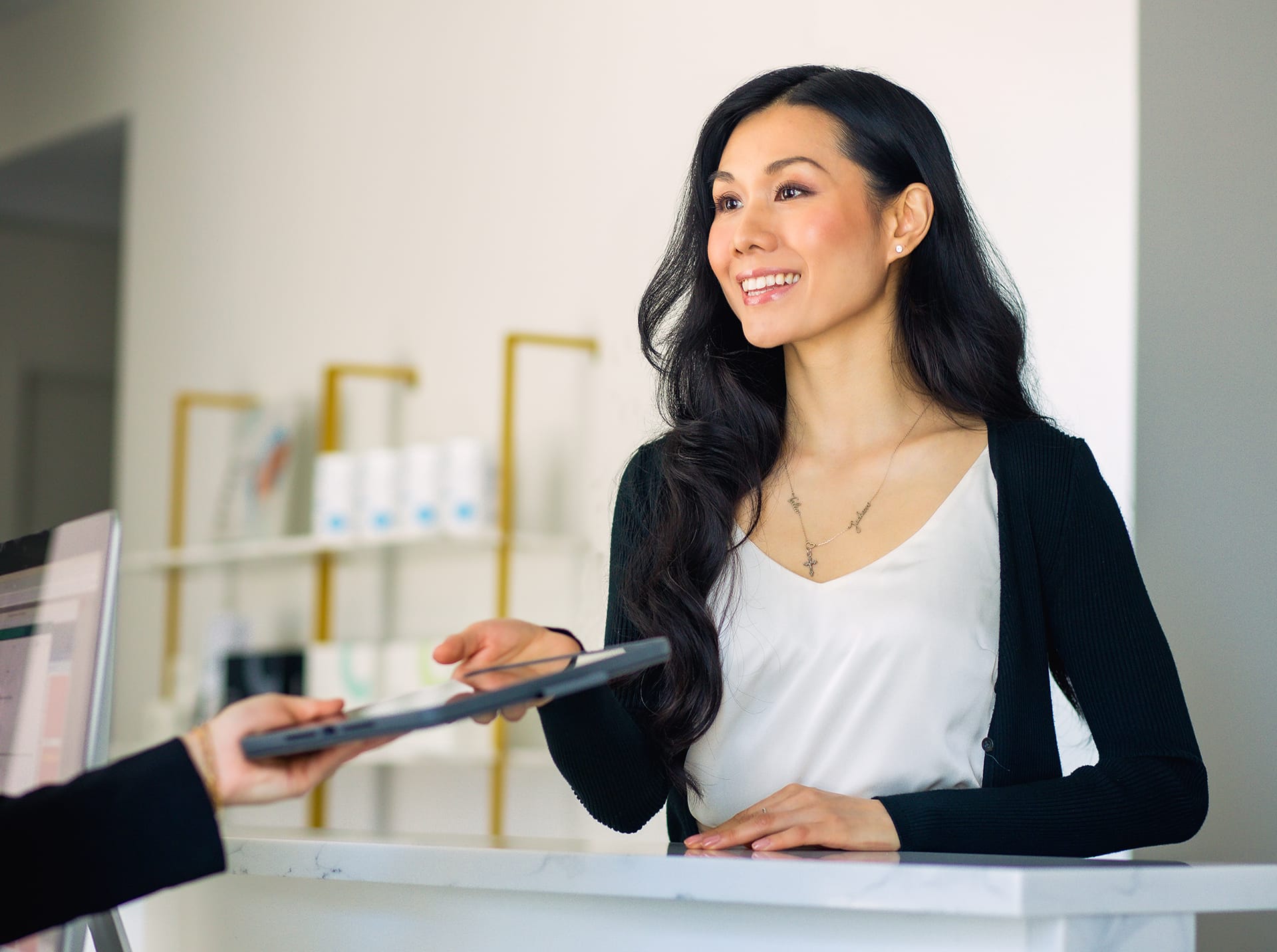 woman handing over an ipad