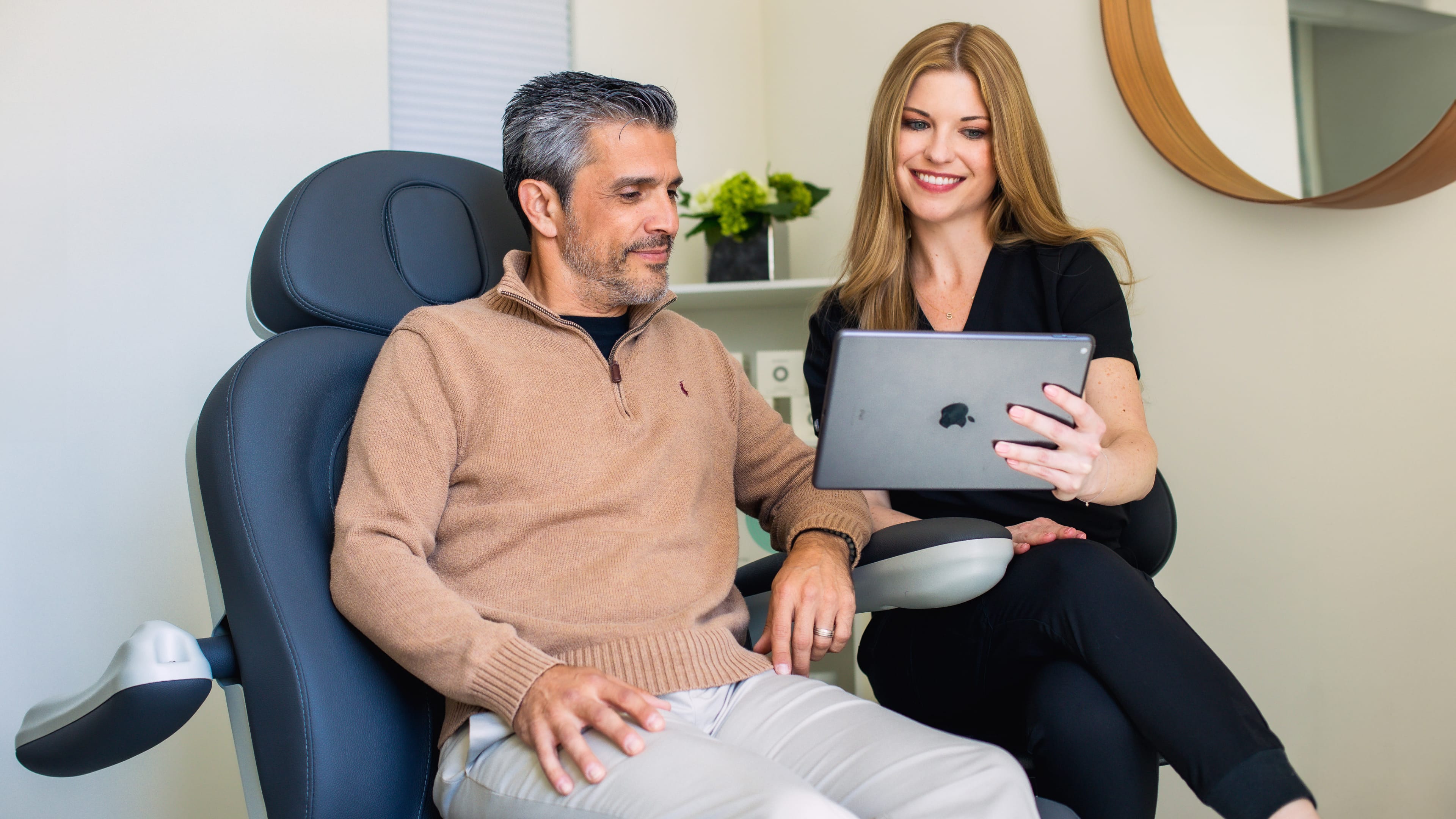 staff and patient looking at an ipad